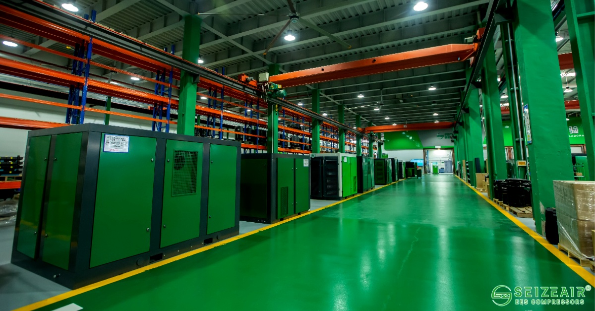 Industrial screw compressor installation in manufacturing facility