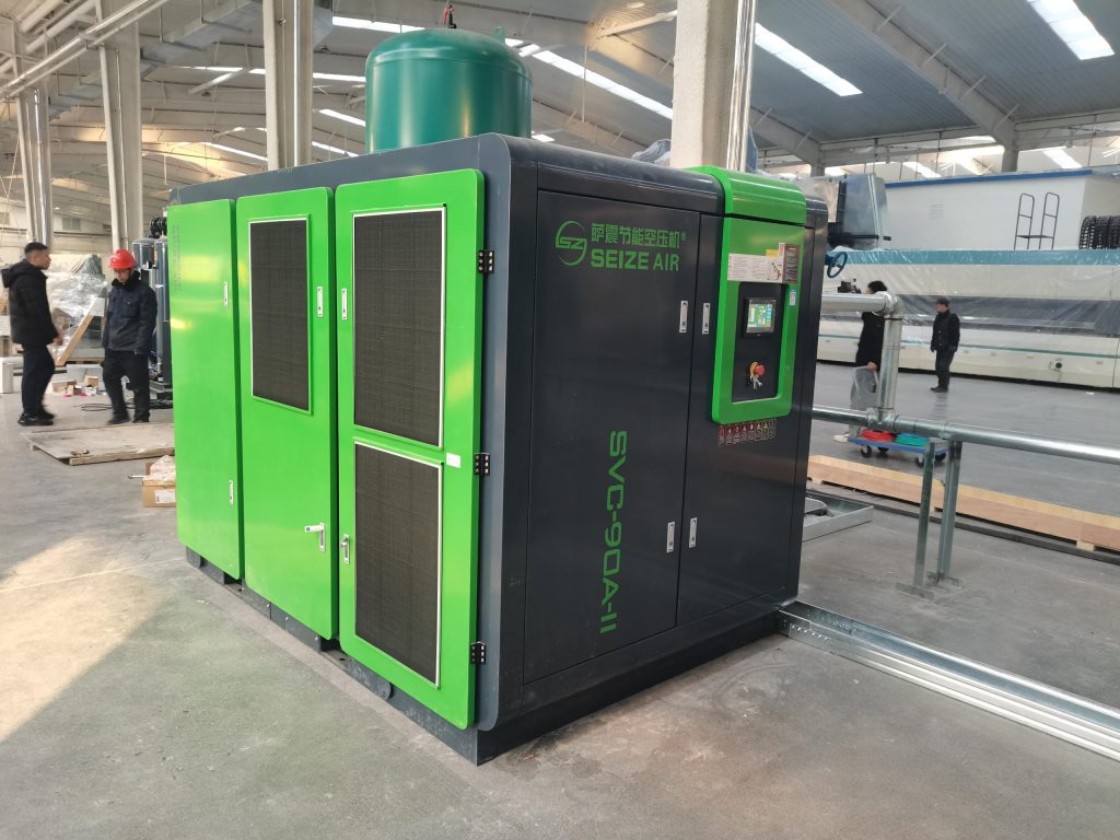 Industrial screw compressor installation in manufacturing facility